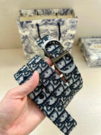 Dior belt detail, logo-print strap with oval metal buckle in hand
