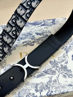 Designer belt with black pebble-texture keeper and black-and-white Dior monogram strap