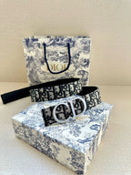 Designer belt with black-and-white Dior monogram strap and silver buckle with keeper