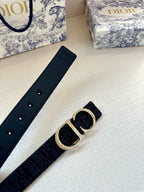 Dior belt flat lay: dark blue strap with gold CD buckle and stud holes