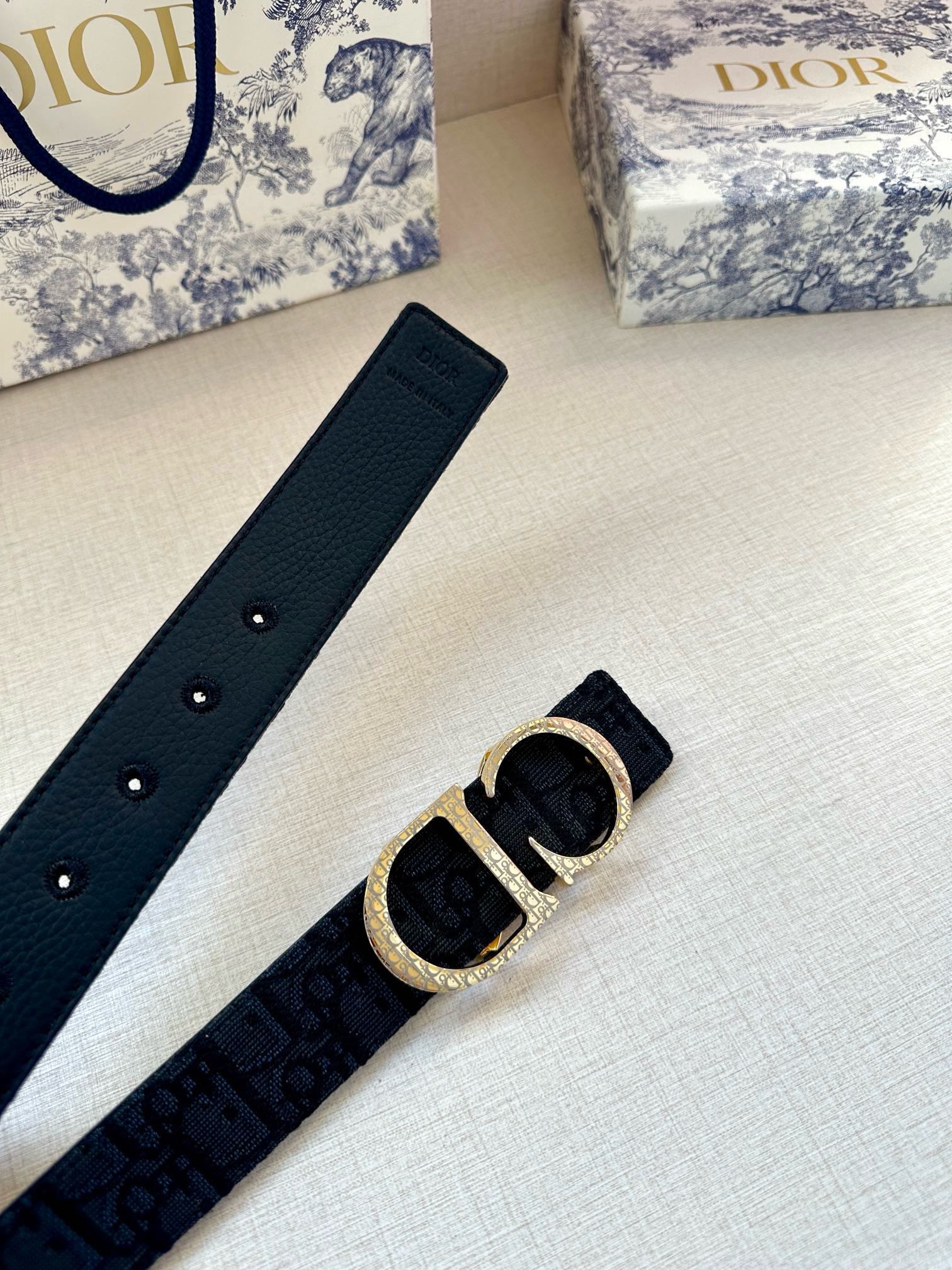 Dior belt flat lay: dark blue strap with gold CD buckle and stud holes