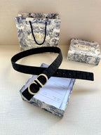 Dior belt with dark strap and gold CD buckle, shown on packaging