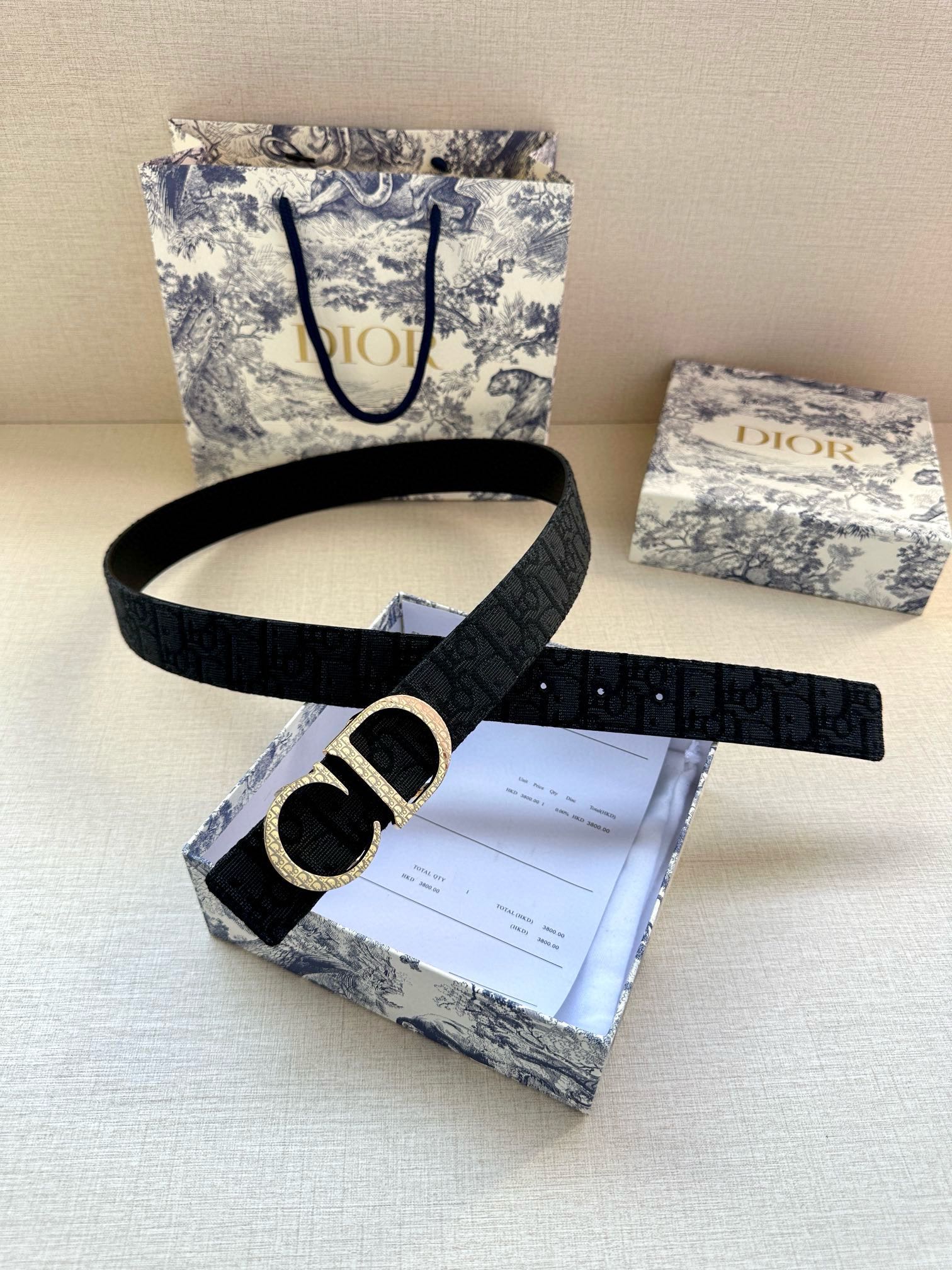 Dior belt with dark strap and gold CD buckle, shown on packaging