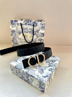 Dior belt with dark blue strap and gold CD buckle on display packaging