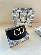 Dark leather belt with CD gold-tone buckle and monogram pattern.