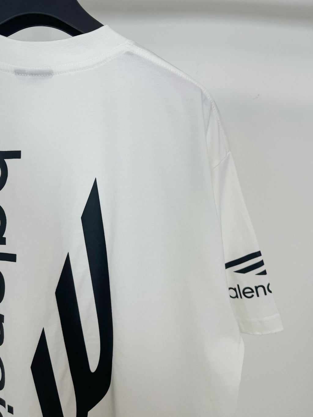 White Balenciaga T-shirt with 'alenc' sleeve logo and large back icon detail