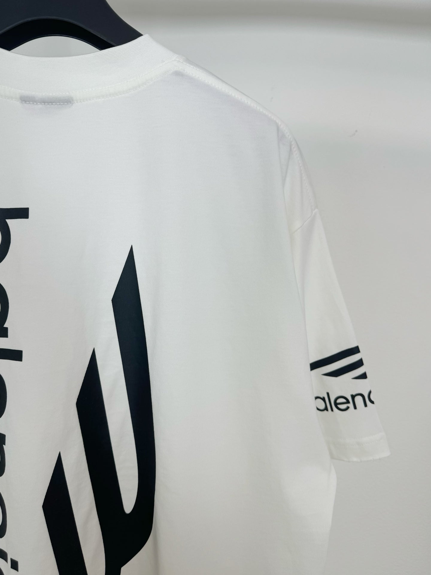 White Balenciaga T-shirt with 'alenc' sleeve logo and large back icon detail