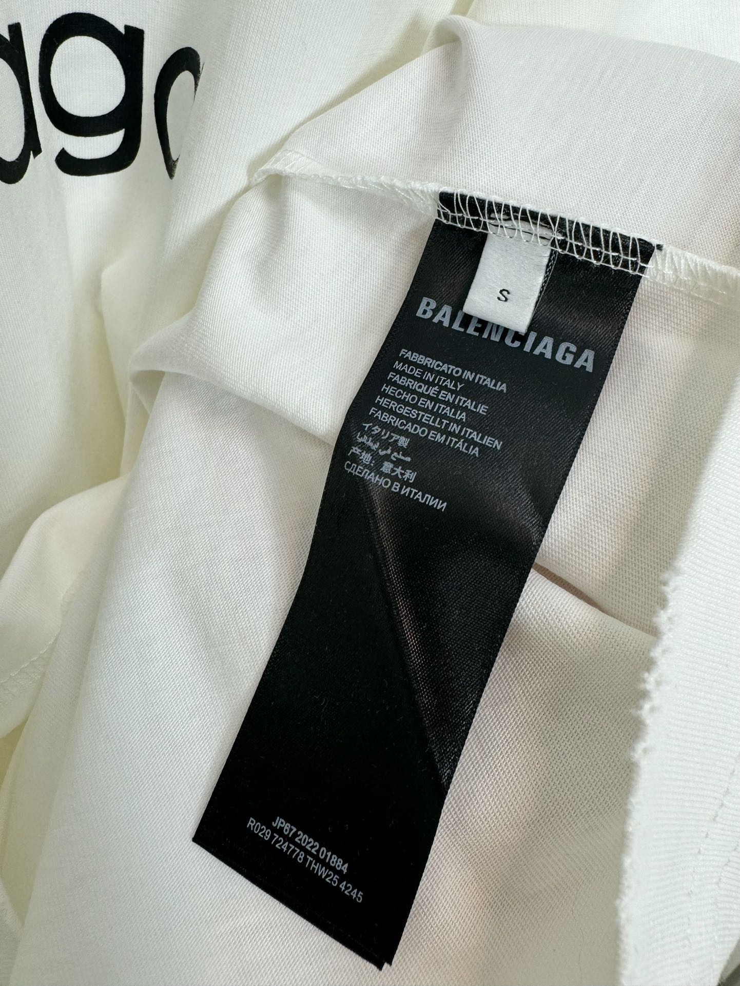 White Balenciaga T-shirt with black brand label tag at collar