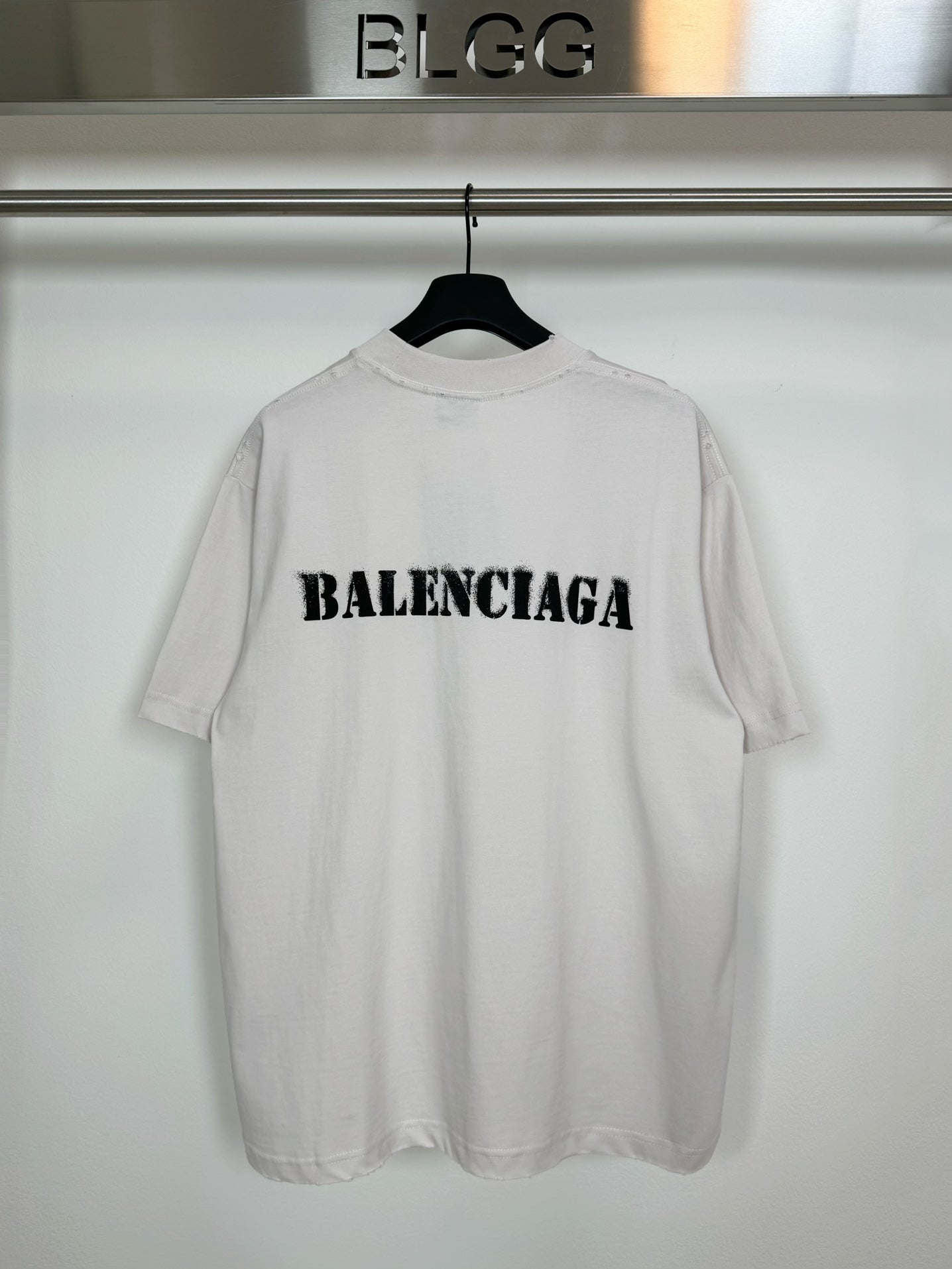 White short-sleeve T-shirt with black BALENCIAGA logo on the back