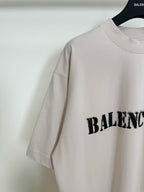 White short-sleeve T-shirt with black BALENCIAGA logo partially visible on the side
