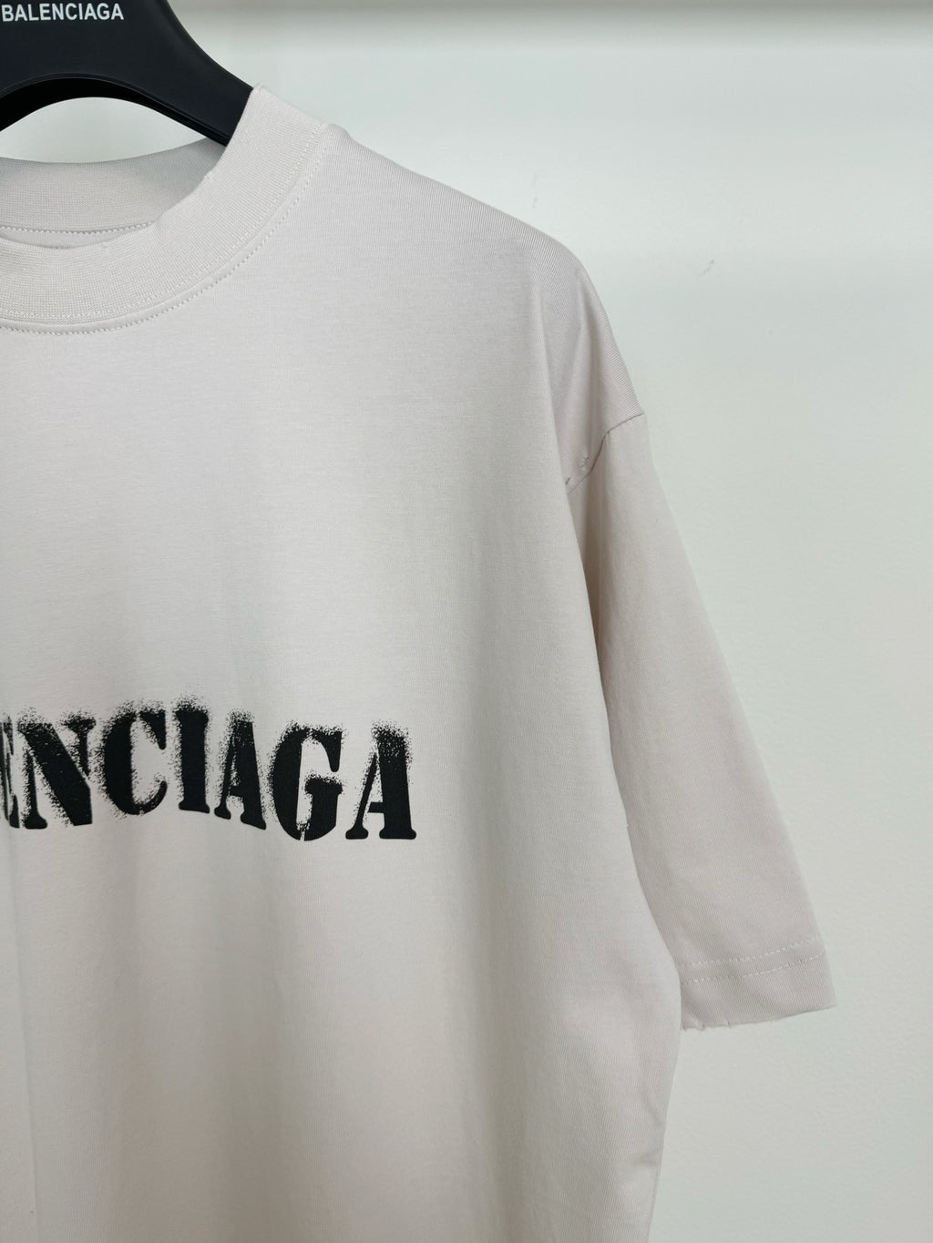 White short-sleeve T-shirt with black BALENCIAGA lettering on the chest, partial