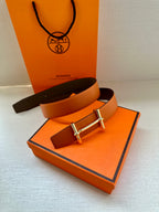 Hermes orange leather belt with silver buckle on box