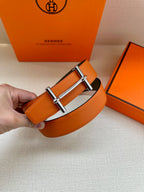 Hermes orange leather belt held up with silver bar buckle