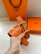Hermes orange leather belt with silver buckle and punched hole
