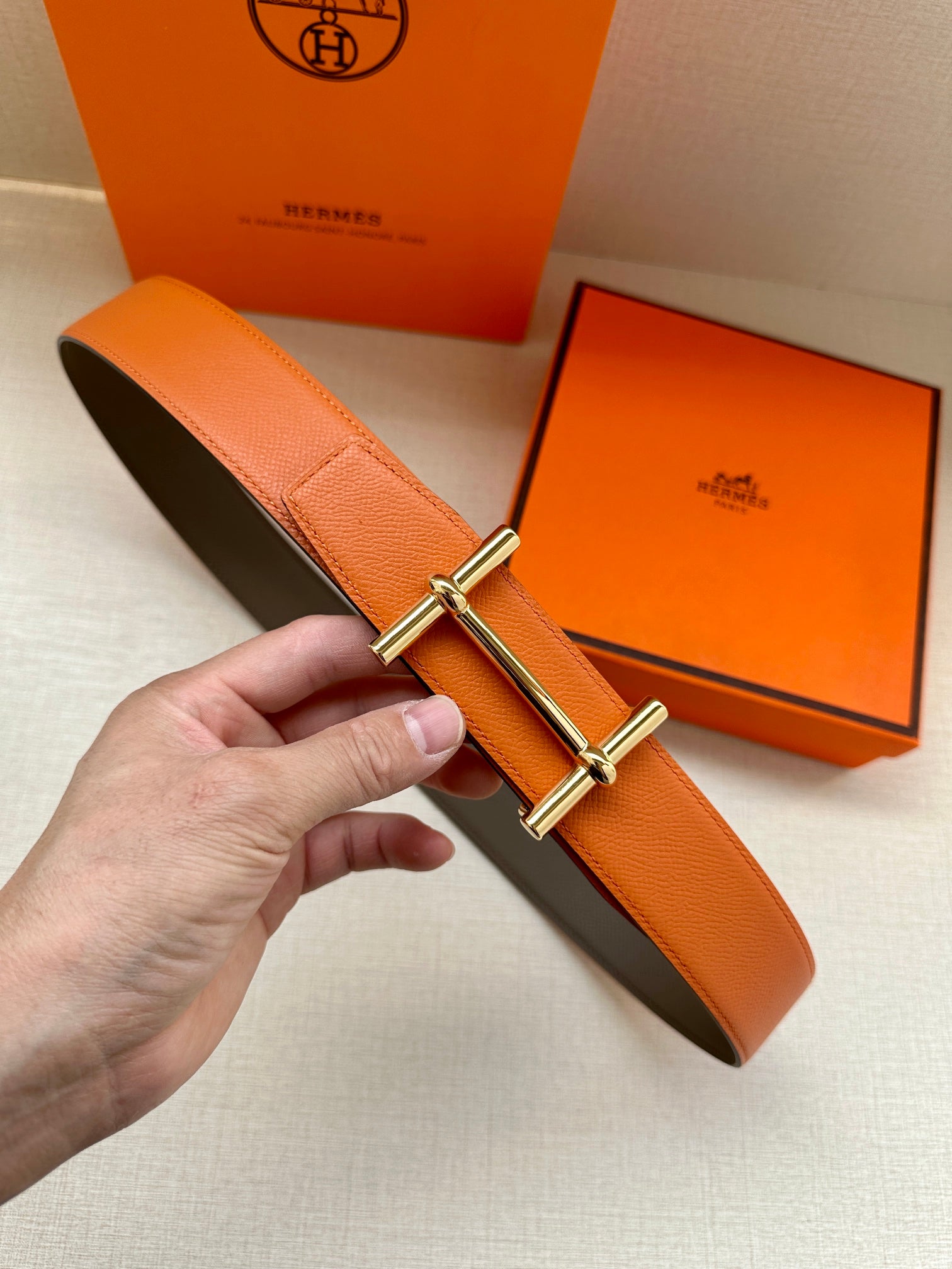 Hermes belt in orange leather with silver bar buckle