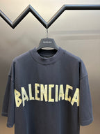 Dark blue Balenciaga short-sleeve T-shirt with large BALENCIAGA logo text across front.