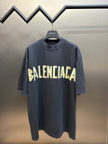 Dark blue Balenciaga short-sleeve T-shirt with BALENCIAGA text graphic at chest.