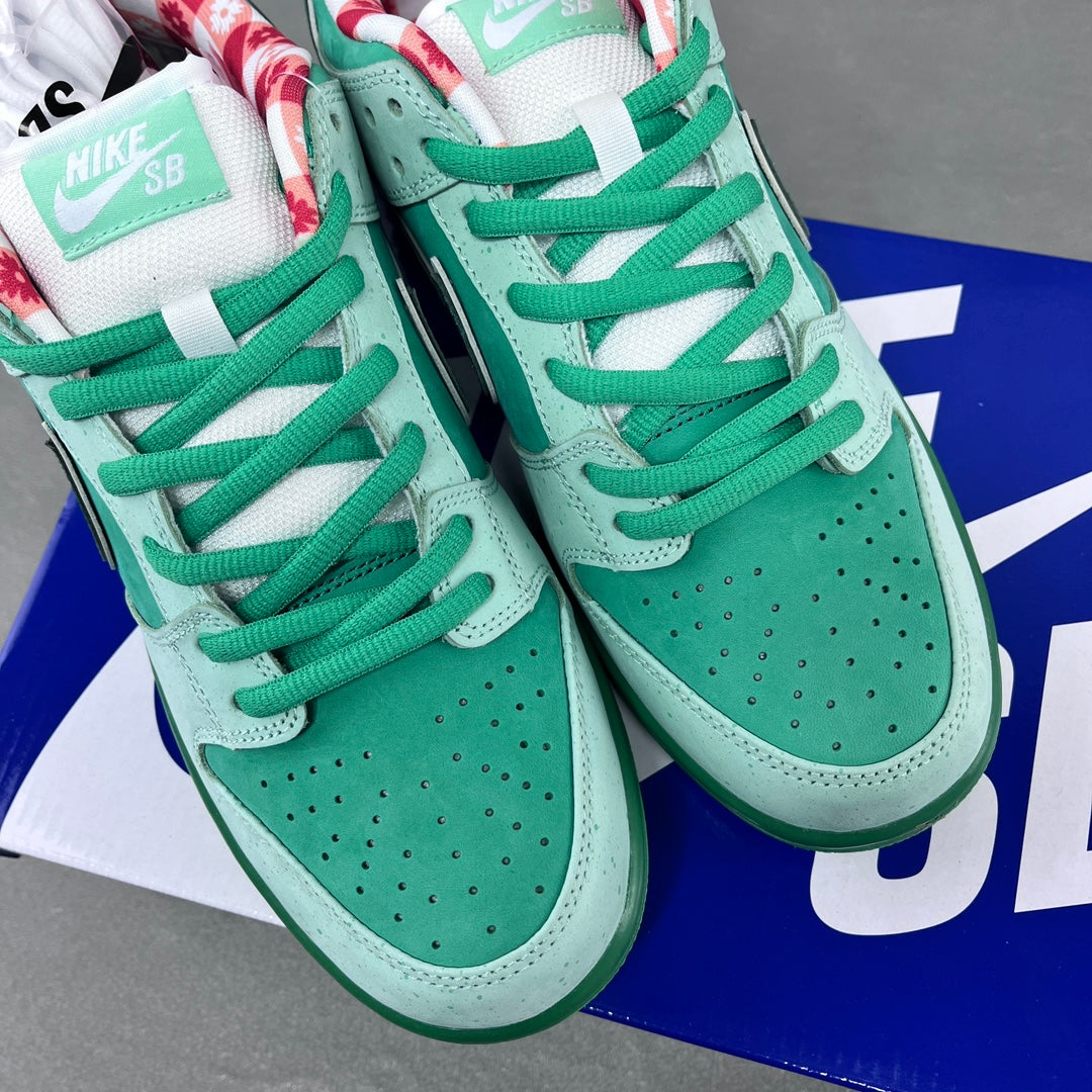 Pair of seafoam low-top sneakers with green laces and perforated toe