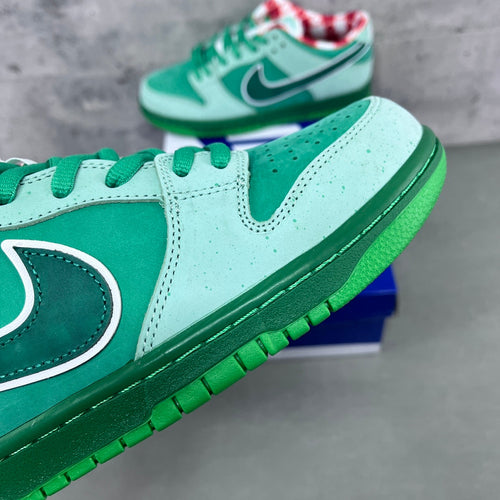 Low-top sneaker side view in seafoam suede with dark green swoosh and white stripe