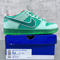 Seafoam and dark green low-top sneakers with green laces and Nike swoosh