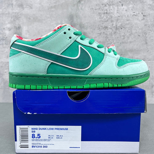 Seafoam and dark green low-top sneakers with green laces and Nike swoosh