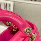 Pink leather handle strap with gold rings and metal hardware on Dior handbag