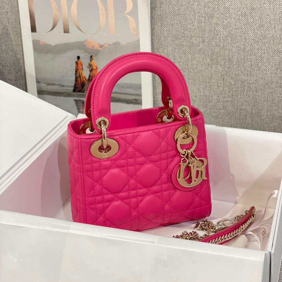 Pink quilted Dior handbag with top handles and gold hardware, small size