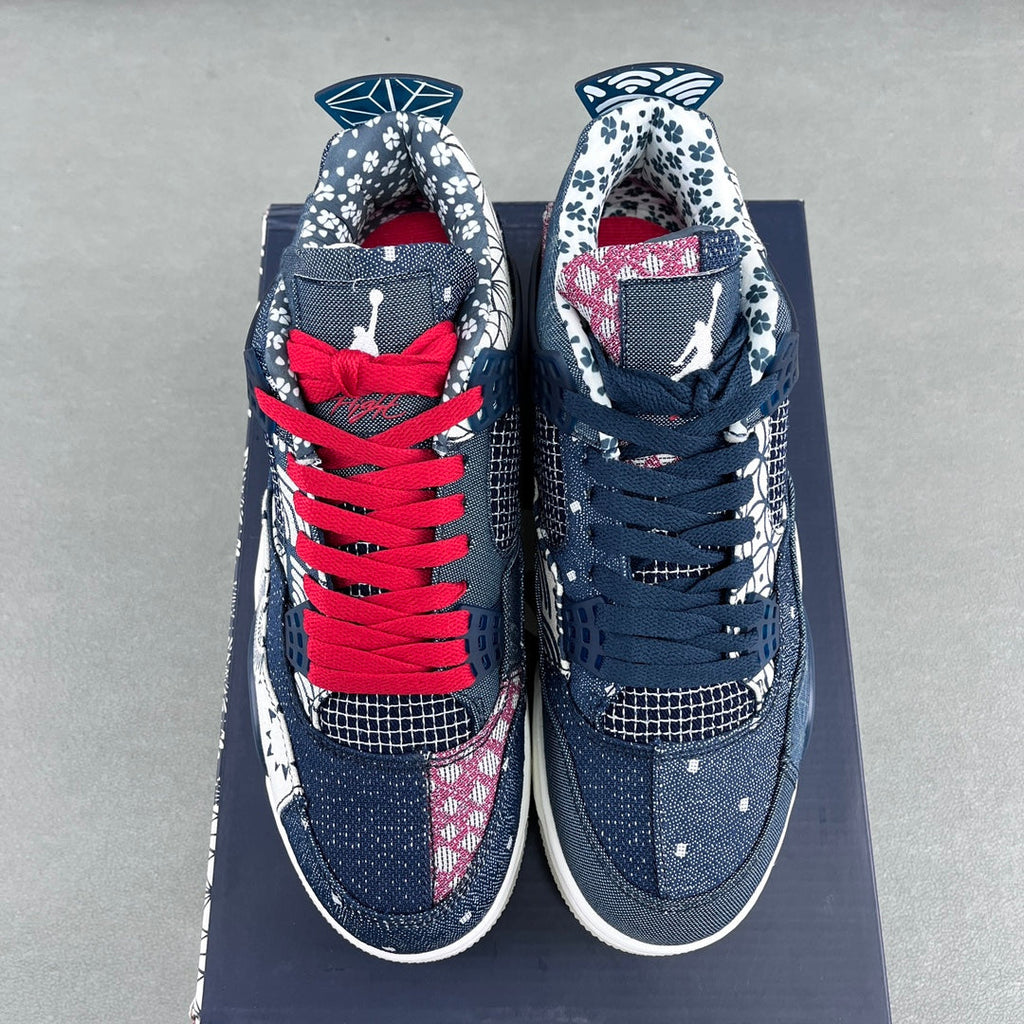 Two navy sneakers with red lace-up front, white midsoles, and lace-area graphics