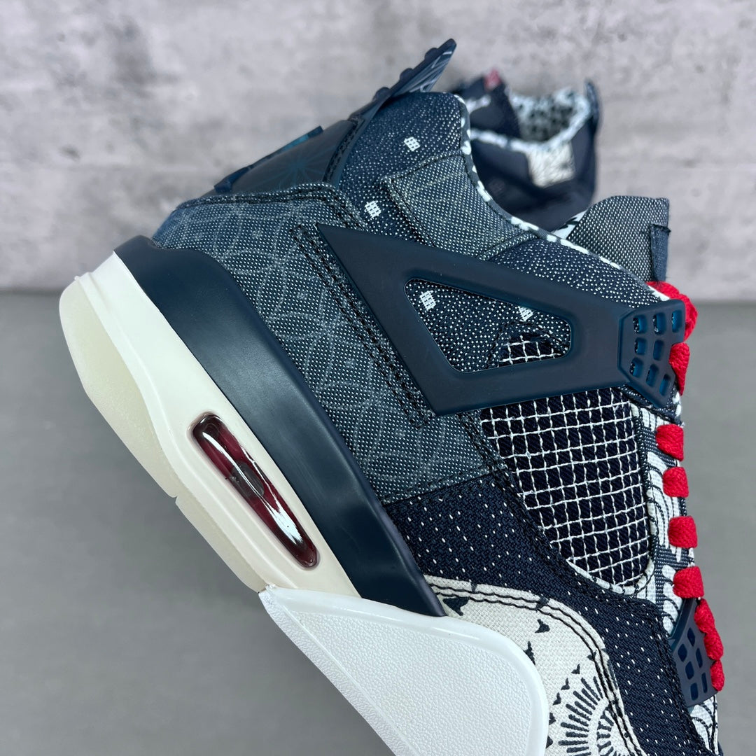 Navy Air-style sneaker side view with red laces and white sole detail