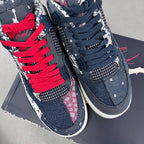 Pair of navy sneakers with bright red laces, white midsoles, and patterned uppers