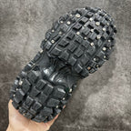 Balenciaga sneaker bottom view with square tread blocks and metal studs