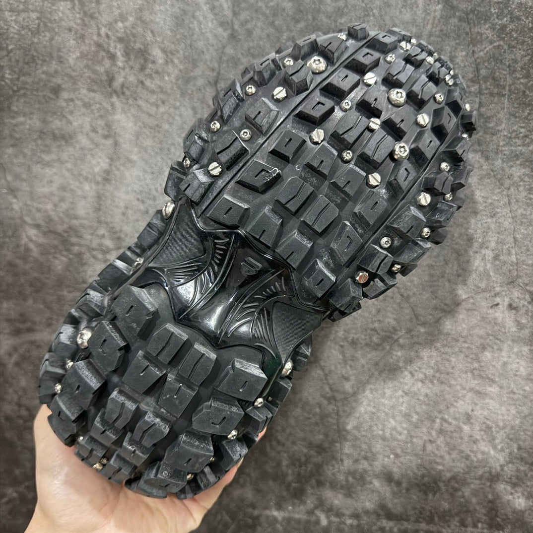 Balenciaga sneaker bottom view with square tread blocks and metal studs