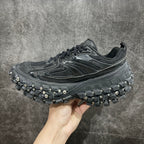 Balenciaga sneaker with textured upper, black laces, and studded tread sole