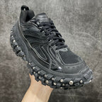 Balenciaga sneaker with mesh-textured upper, black laces, and studded rubber sole