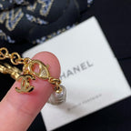Pearl-bead bracelet with gold charms including heart and CC logo
