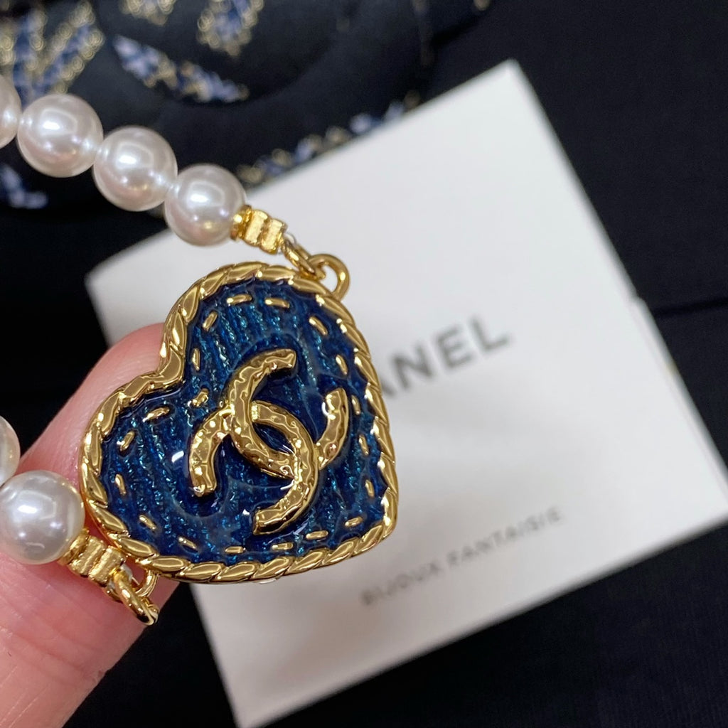 Blue enamel heart pendant on pearl-bead bracelet with gold link chain
