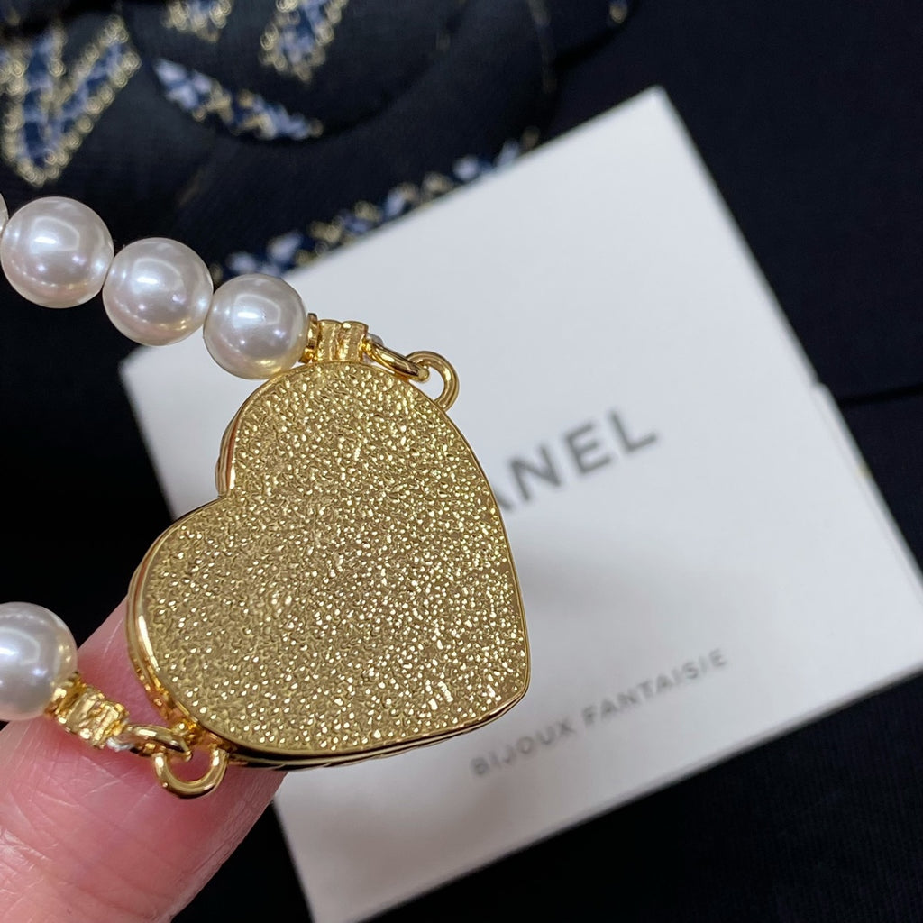 Gold glitter heart charm on pearl-bead bracelet with gold clasp