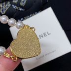 Gold glitter heart charm on pearl-bead bracelet with gold clasp