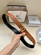 Brown leather belt with gold-tone double-C buckle and pierced holes.