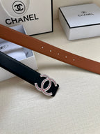 Brown and black leather belt straps with double-C buckle and jeweled insets.