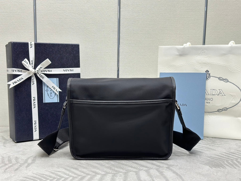 Prada boxy crossbody bag with curved top flap and shoulder strap, black