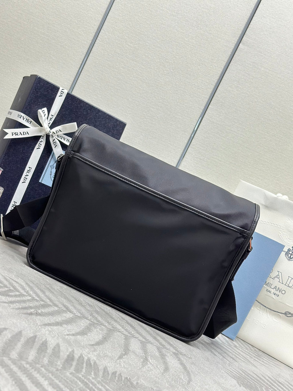 Prada shoulder bag with long strap, matte finish, and front flap side view