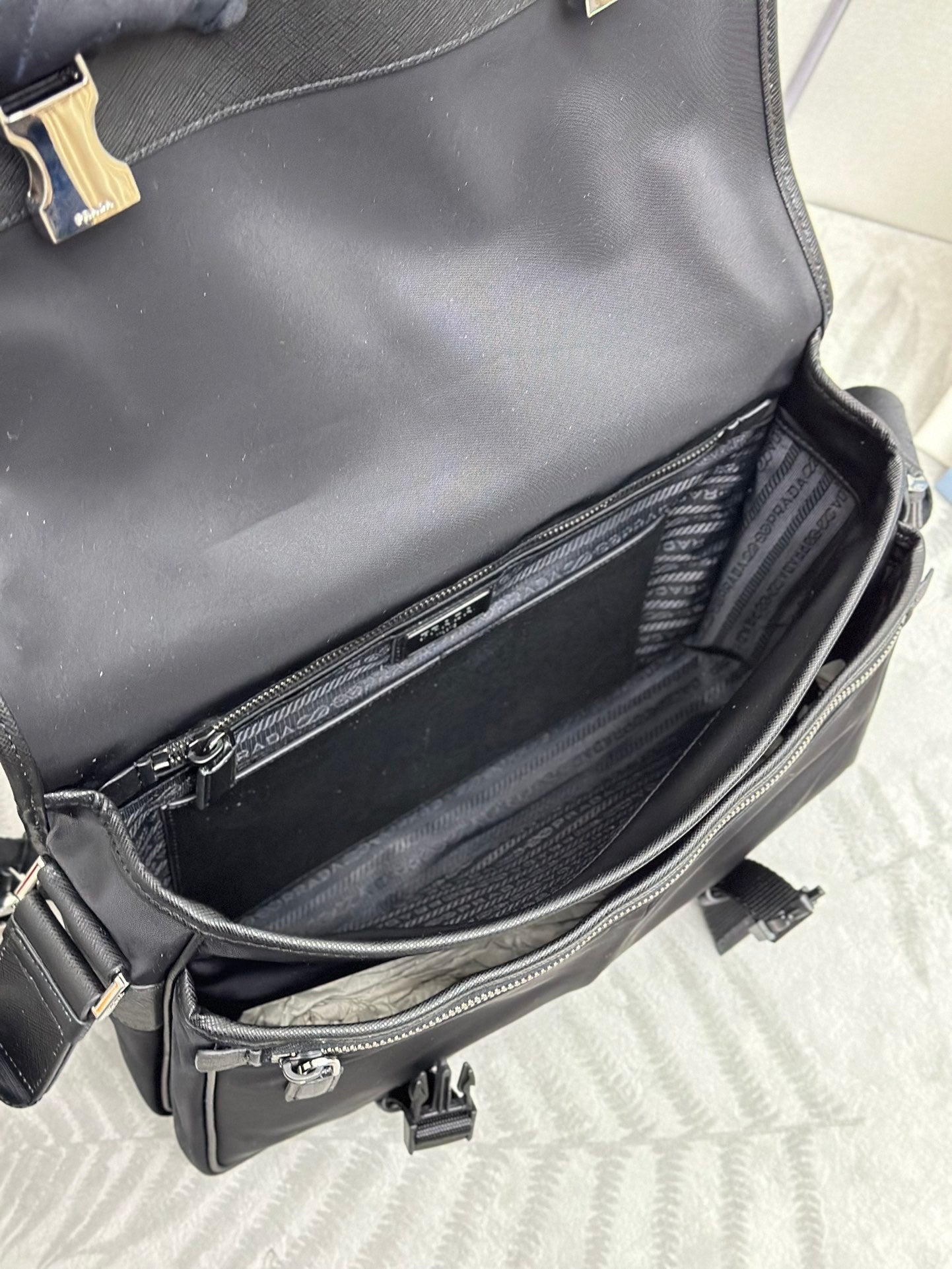 Prada bag open view showing interior compartment and zip pocket