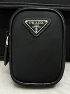 Prada mini crossbody pouch with triangular logo plaque and zipper closure