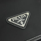 Prada triangular logo patch on black zip pouch with textured border
