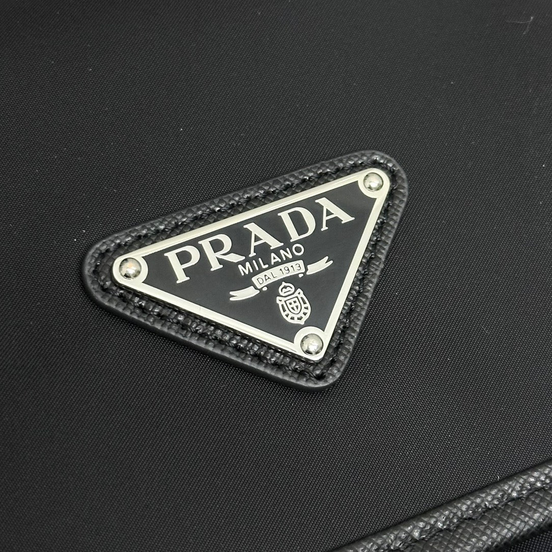Prada triangular logo patch on black zip pouch with textured border