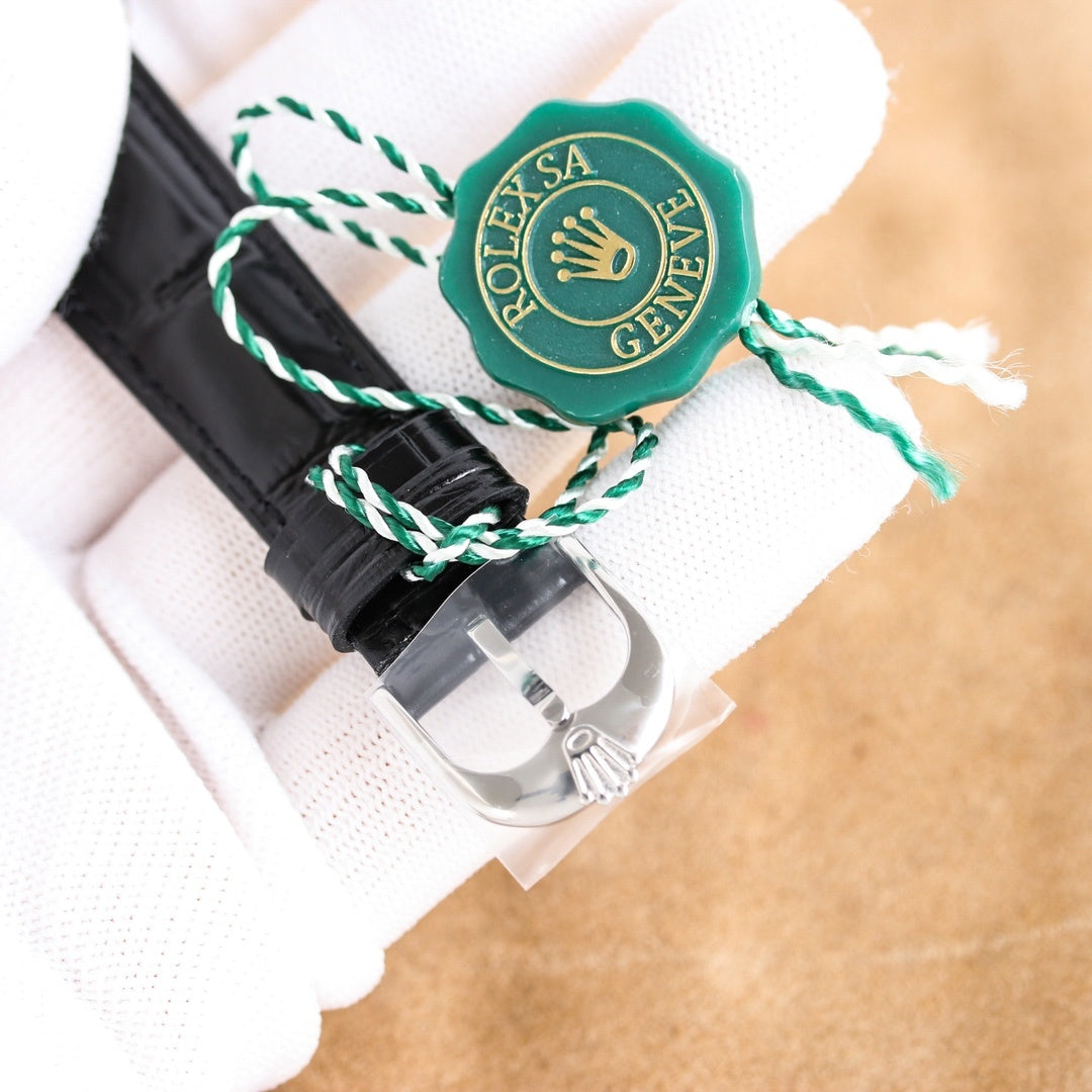 Rolex wristwatch buckle and strap end with green seal, silver clasp