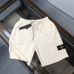 Off-white drawstring shorts with Stone Island logo patch on pocket