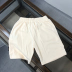 Off-white drawstring shorts with elastic waistband and side seams