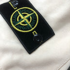 Stone Island logo patch on off-white shorts with fabric button